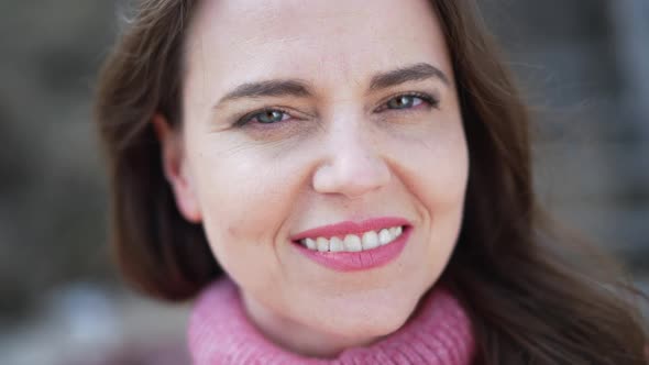 Front View Headshot of Beautiful Caucasian Woman Smiling Looking at Camera Standing Outdoors