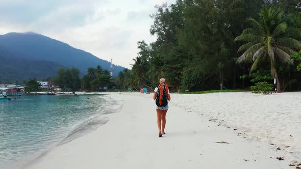 Beautiful women sunbathing on exotic coast beach journey by transparent ocean and white sandy backgr