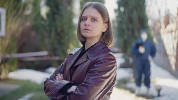 Side View Confident Charming Female Detective Crossing Hands Looking at Camera Standing at Crime