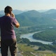 Man is talking on a mobile phone on a mountain landscape background, Altai, Russia - VideoHive Item for Sale