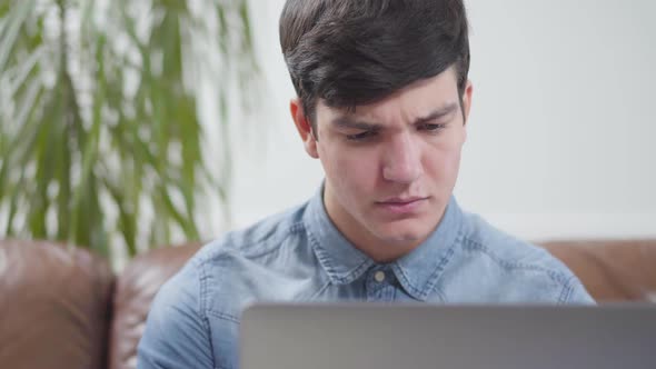 Portrait Handsome Young Man Sitting in Front of Laptop at Home