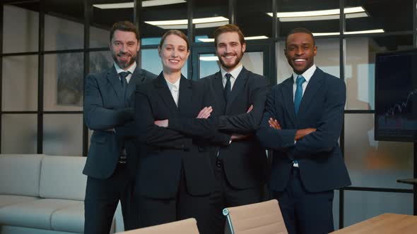 Smiling people in a suit in the office. Business people looking at camera