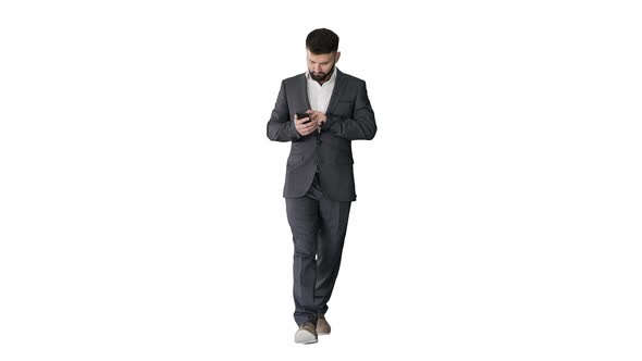 Businessman Walking and Using the Phone on White Background.