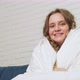 Woman is Wrapped in White Blanket Sitting and Smiling - VideoHive Item for Sale