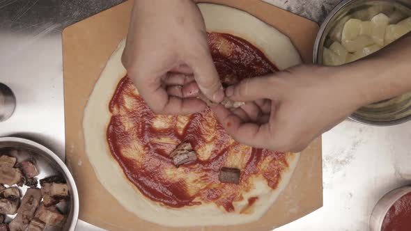 Topping Pizza Dough With Beef Before Baking. overhead