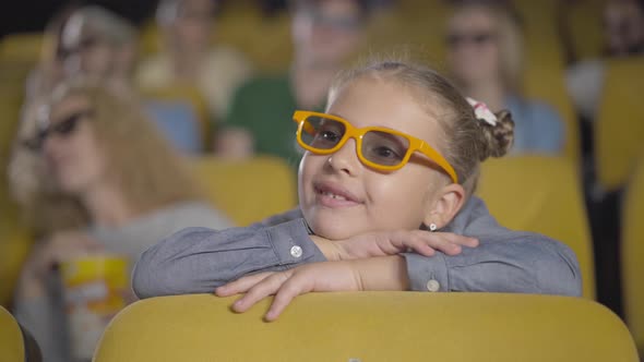 Charming Absorbed Caucasian Girl Watching 3d Film in Cinema. Portrait of Beautiful Little Child in