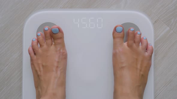 Female Bare Feet Stepping on Digital Floor Scales  Woman Weighing Herself