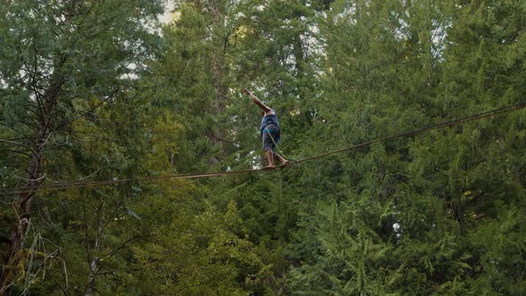 Fit Man High-lining Over A Waterfall