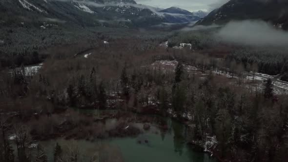 Cloudy Aerial tilting shot of winter valley on Vancouver island, Canada