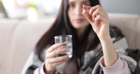 Sick Woman Holding Medicine Capsules and Glass of Water Closeup  Movie