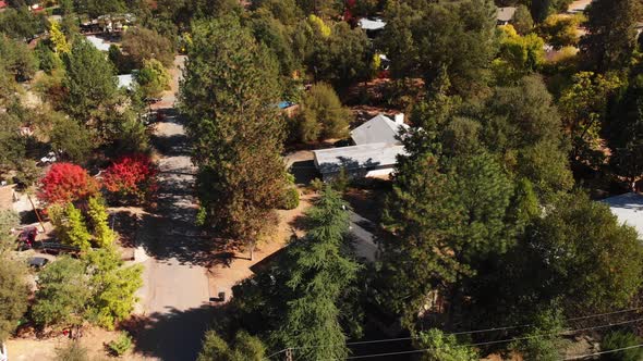 Residential houses in mountain community from slow panning overhead aerial view