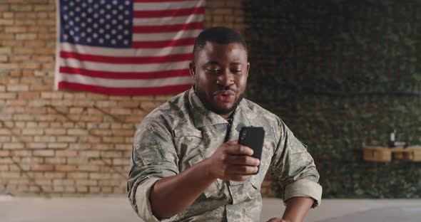Black Soldier Making Video Call in Gym