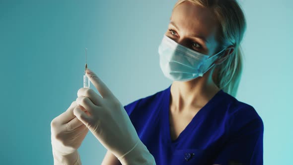 Woman Doctor at the Clinic Preparing Anaesthesia for the Patient