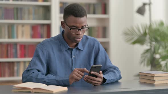 Upset Young African Man Reacting to Loss on Smartphone