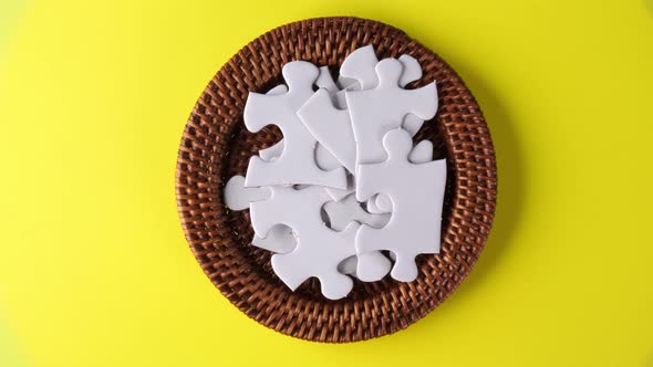 Rotation of white jig saw puzzle