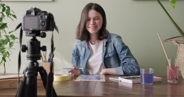 Artist, Teenage Girl, Draws and Records on Video Camera for His Blog