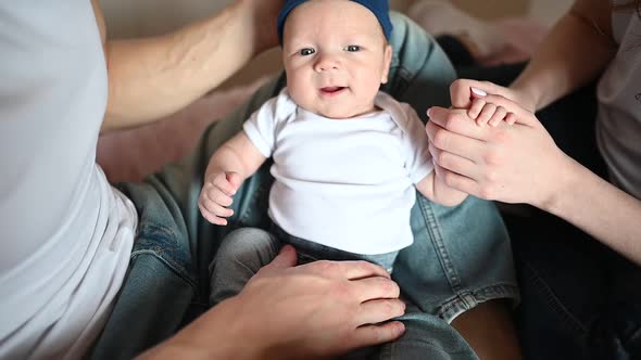 A Hand Holding a Baby