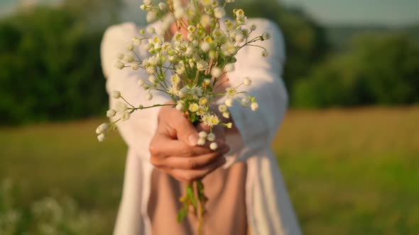 Unrecognizable Woman with Bouquet Wildflowers Outdoors