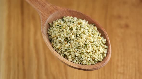 Organic hemp seeds in wooden spoon. Superfood hemp seeds