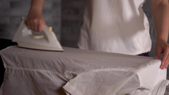 Woman Ironing Clothes on Ironing Board Closeup