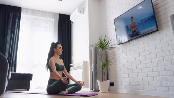 Woman Meditating in Yoga Posture at Home
