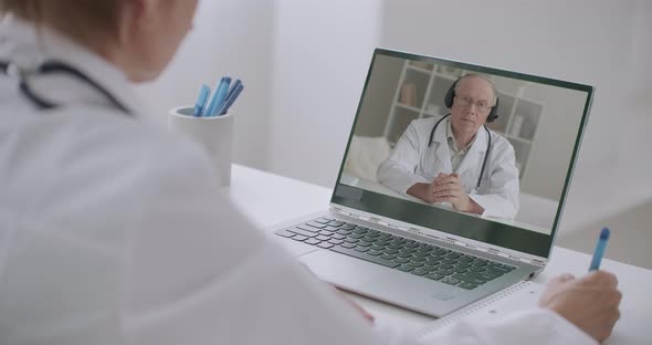 Head Physician of Hospital Is Communicating with Doctors By Video Conference, Woman Is Listing Him