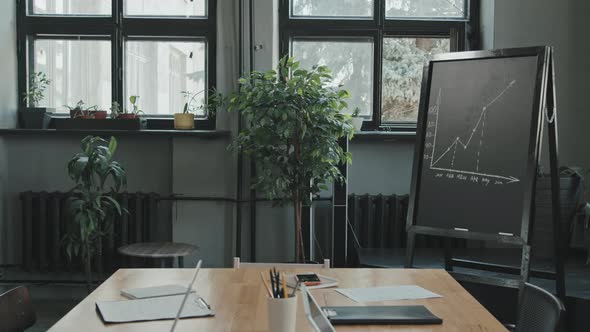 Cozy Workplace with Finance Graph Drawing on Chalkboard