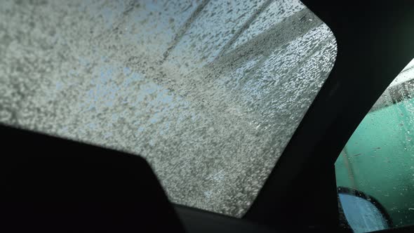 Car Wash Shampoo Covering Windshield of Vehicle