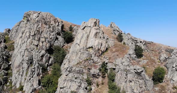 Granite Rock Formation In Macin Mountain Range In Romania Against Blue Sky