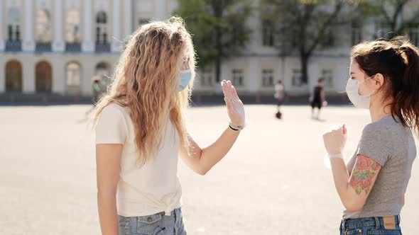 Two Nice Girls in Protective Medical Mask Meet at Street During Pandemic