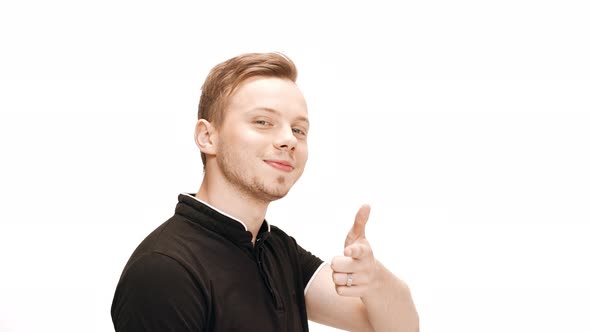 Young Handsome Man Smiling Winking Pointing Finger at Camera Over White Background