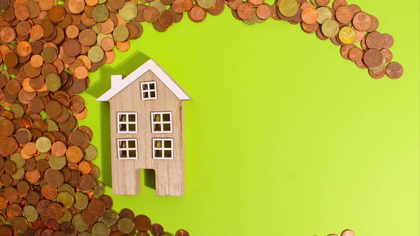 Stop Motion Animation Euro Coins on a Green Background Move Around and Next to a Wooden House