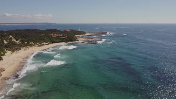 high aerial view of norah head lighthouse and pebbly beach