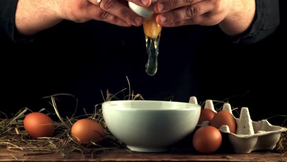 Super Slow Motion Male Hands Smash Raw Egg Into the Bowl