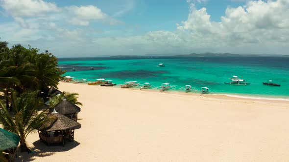 Tropical Daco Island with a Sandy Beach and Tourists