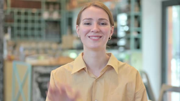 Portrait of Cheerful Young Woman with Ok Sign