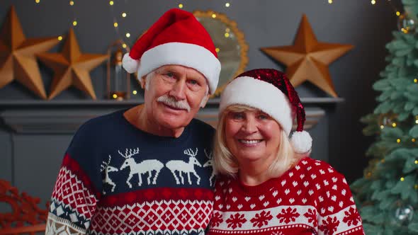 Smiling Married Senior Couple Grandparents Man Woman in Living Room Celebrating Christmas Together