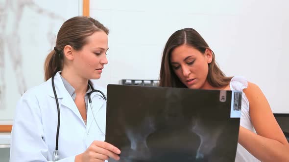 Female doctor showing to a patient a xray