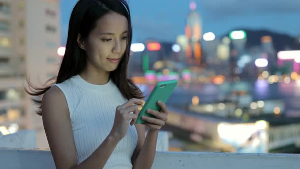 Woman using cellphone at night