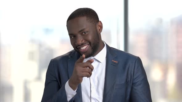 Flirtatious Dark-skinned Man on Blurred Background.