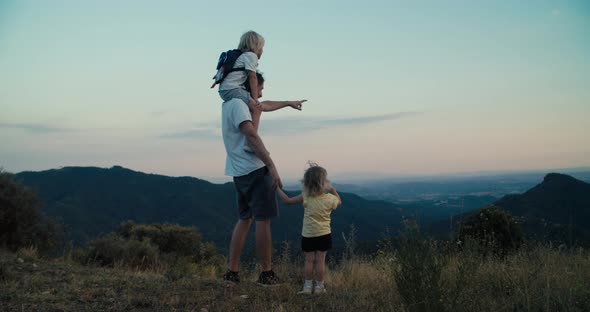 Family on Mountain Travel at Summer Vacation Enjoying Beautiful View at Sunset