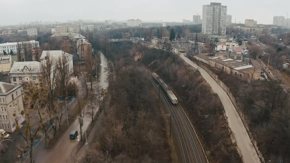 A Rusty Electric Train Moves Along Urban City