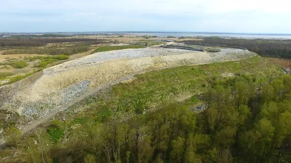 The huge garbage dump on the outskirts of the forest, view from drone