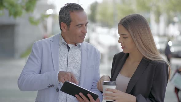 Man and Woman Using Tablet Pc Outdoor