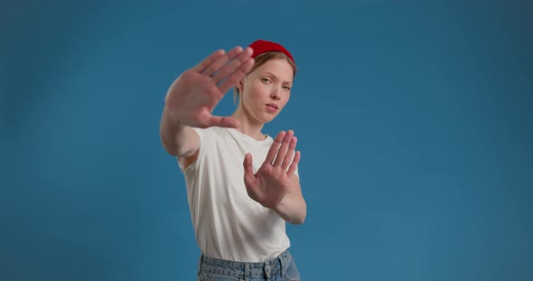 Woman Showing Stop Sign with Outstretched Hand and Saying Dont Show Me This Deny Reject Concept