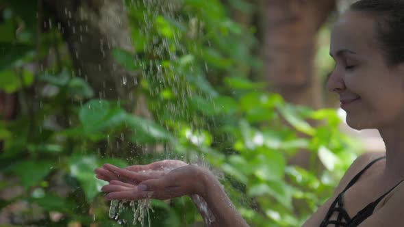 Girl Catches Water Drops and Enjoys Vacation Time in Tropics