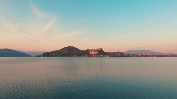 Unique view of Angera perched castle overlooking Lake Maggiore at sunset. Italy