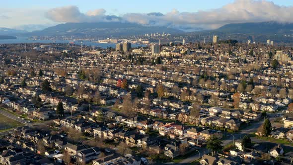 Charming Residential Town In Burnaby Canada With Scenic Mountain Background - aerial shot