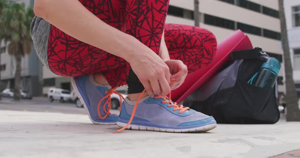 Caucasian woman tying her shoelaces