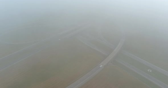 An Early Morning Panorama of Dense Fog Surrounding a Bridge That Crosses the US 65 Highway Near